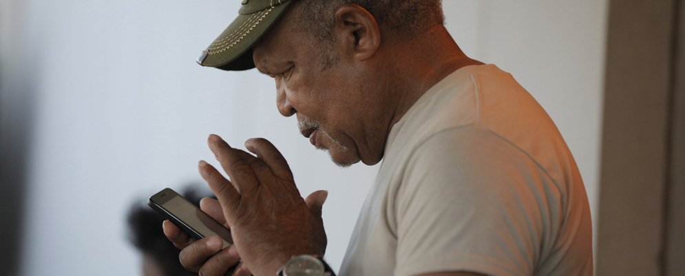 A man uses his smart phone.
